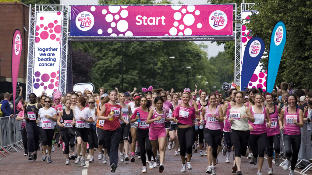 Race for Life start line with large group of female runners wearing pink