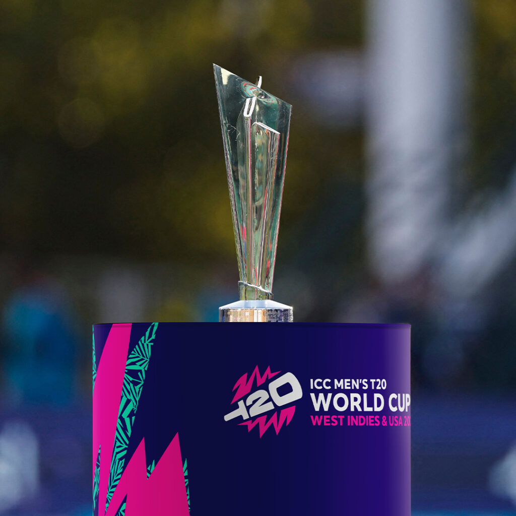 The ICC T20 world cup trophy on a branded purple pink and cyan plinth with the ICC T20 world cup logo