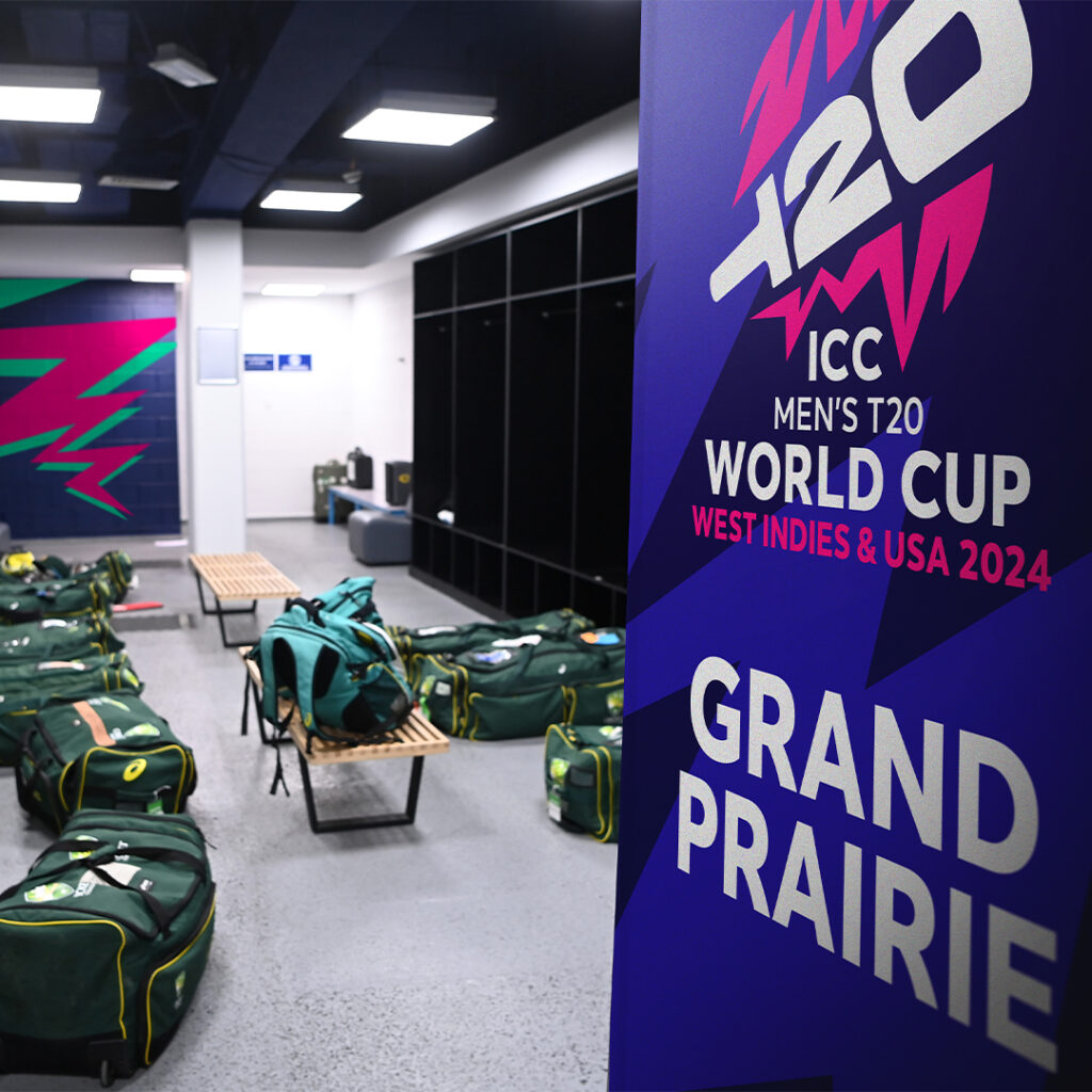 ICC T20 world cup brand shown on the walls in changing rooms - a purple background with the T20 logo and GRAND PRAIRIE written out