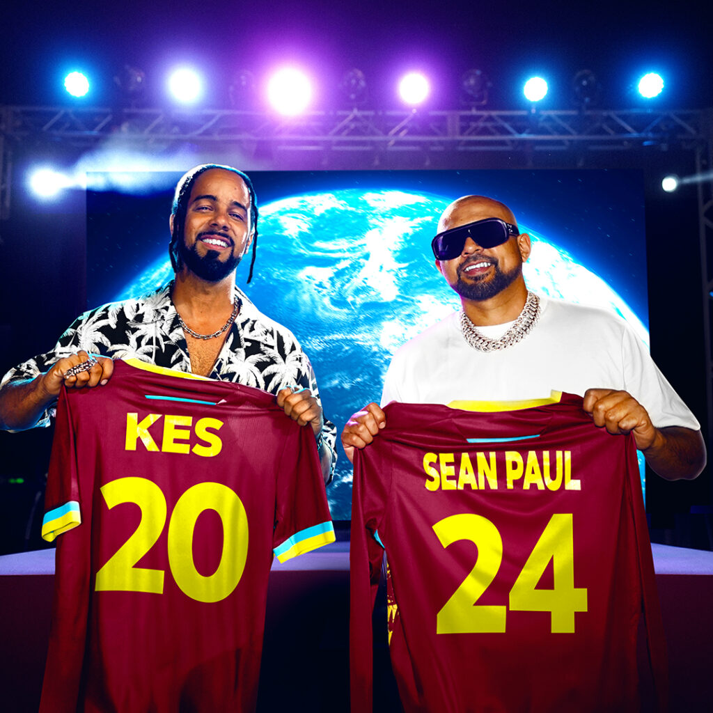 Kes and Sean Paul holding up cricket shirts in front of stage for ICC Out Of This World anthem music video