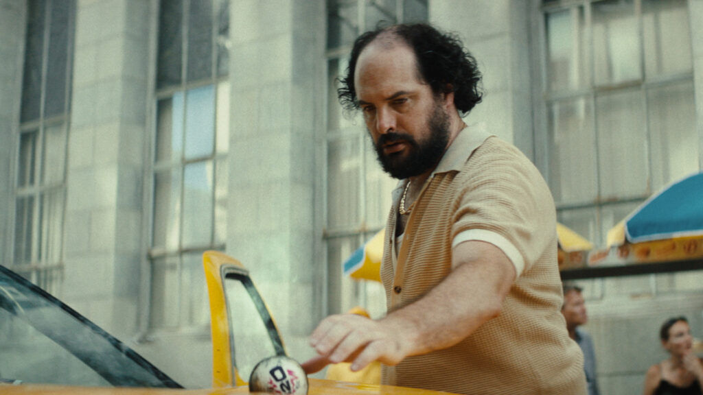 Still from ICC World Cup TV commercial of taxi driver picking up burning cricket ball from taxi bonnet