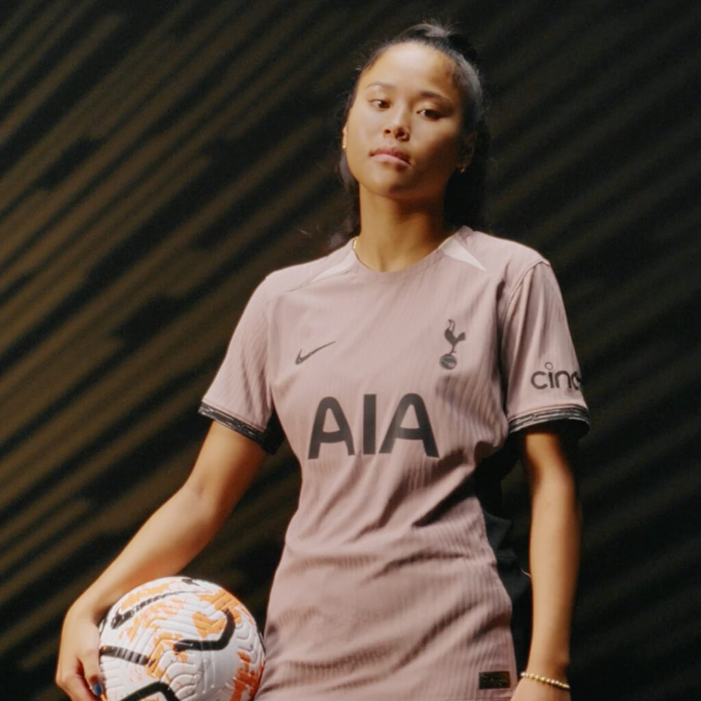 Ali posed with football on hip wearing Tottenham Hotspurs football kit