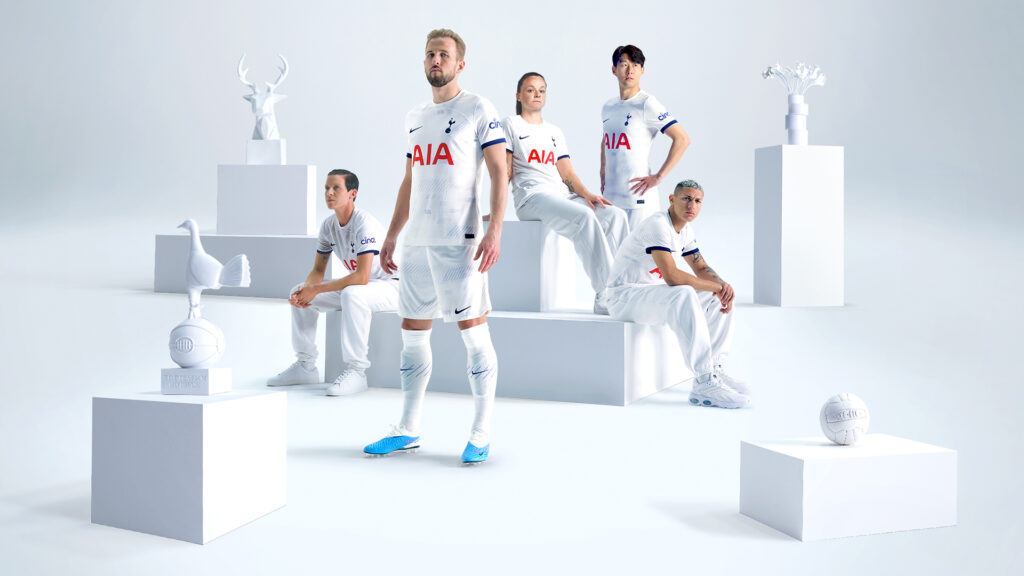 Tottenham Hotspurs players standing in a white gallery backdrop with various white props