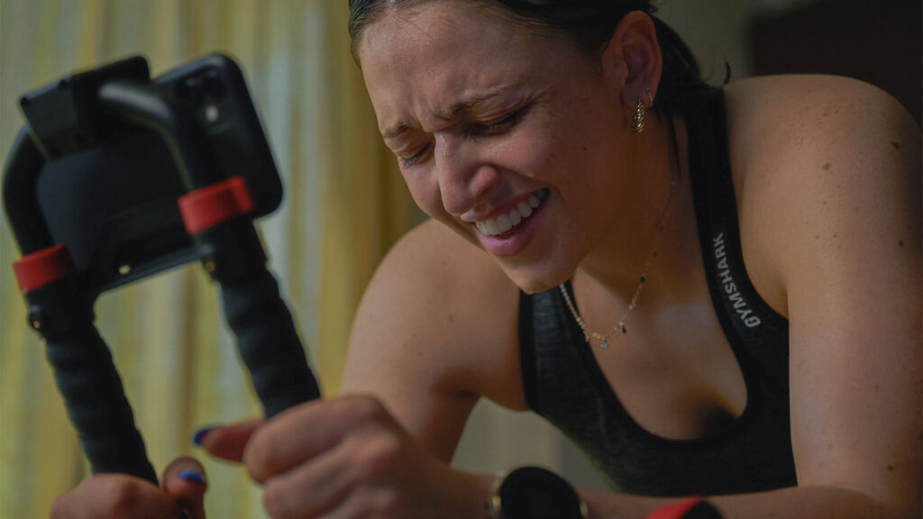 Woman smiling after an intense workout on her Wattbike.