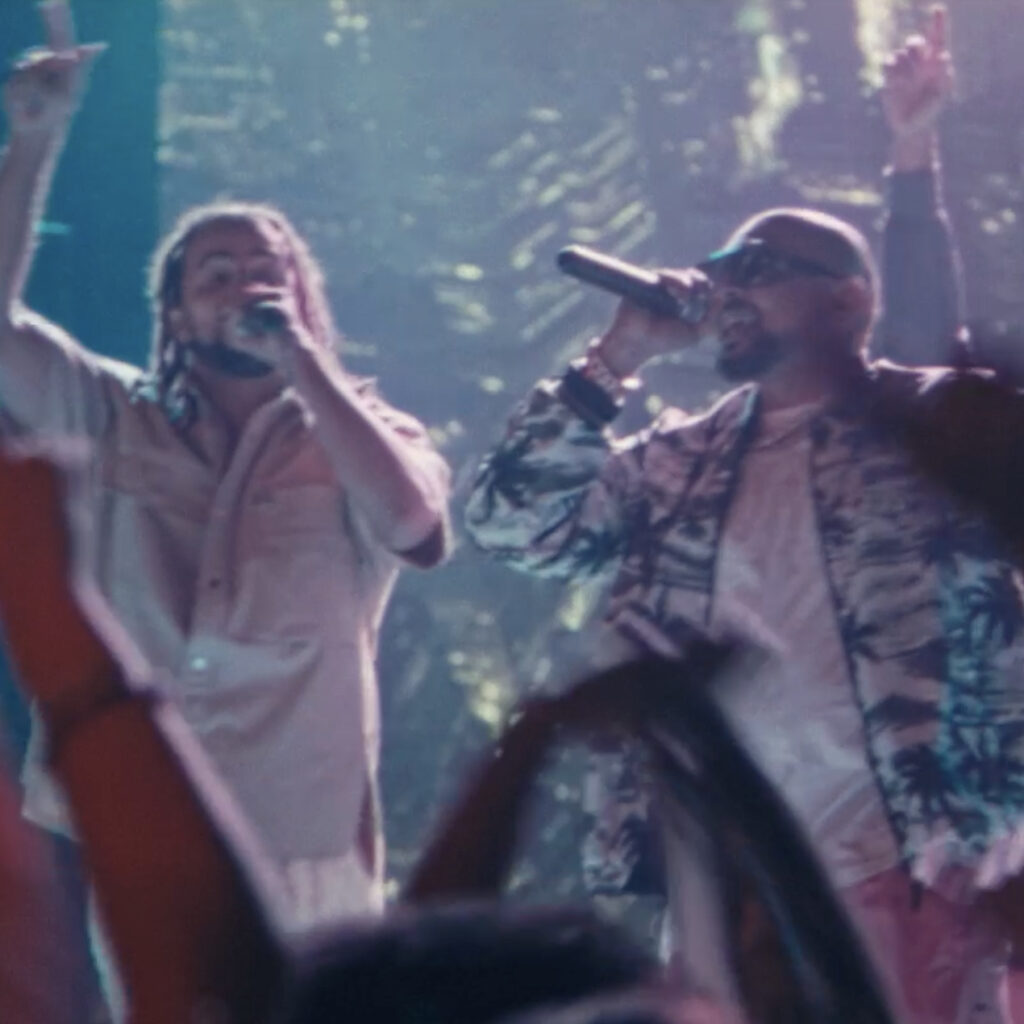 Kes and Sean Paul singing on stage in Out Of This World music video