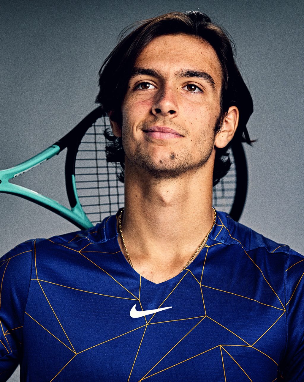 Lorenzo Musetti holding a tennis racket