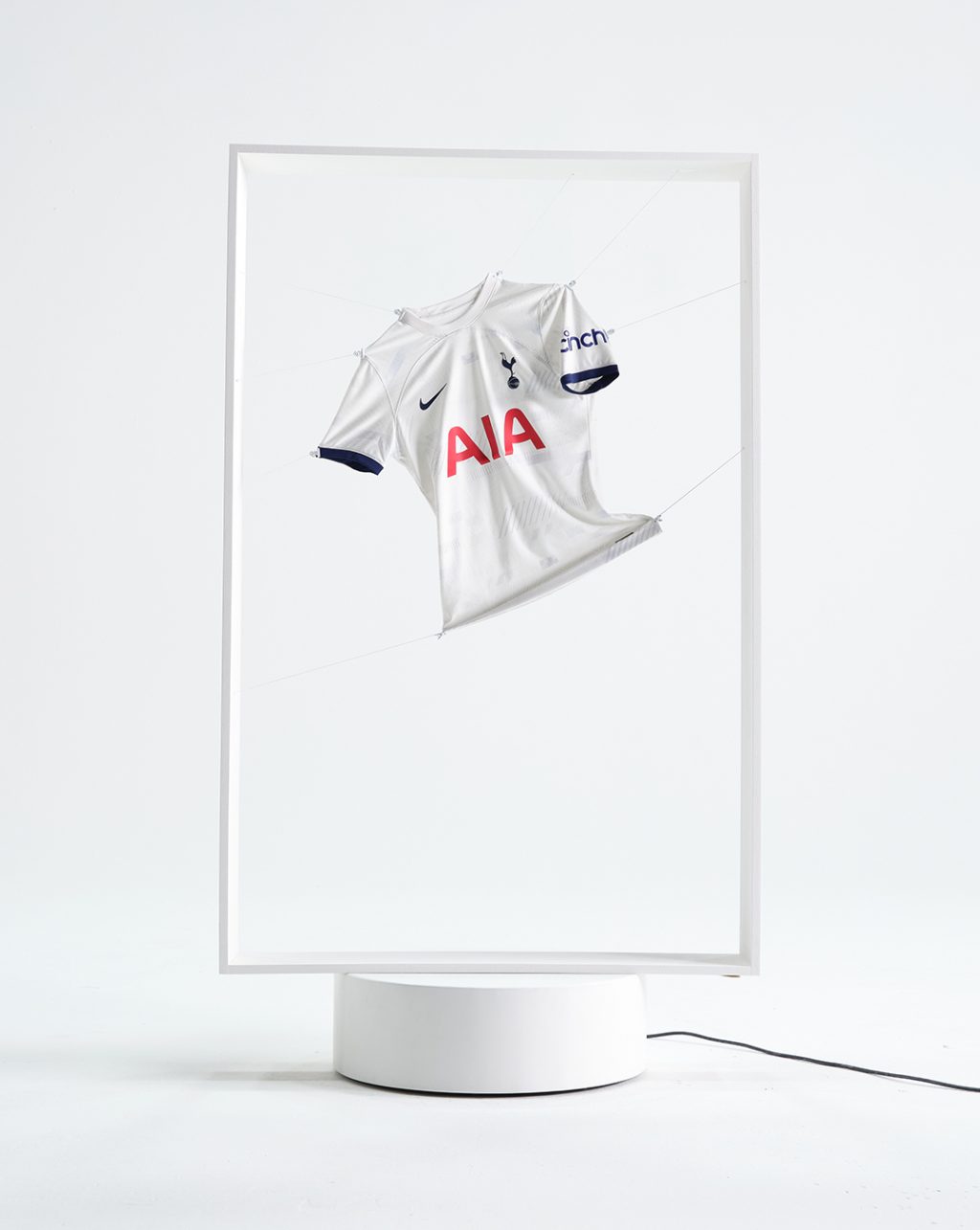 Tottenham Hotspurs home kit shirt in white frame on white studio background